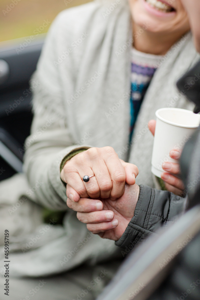 Affectionate senior couple holding hands in car