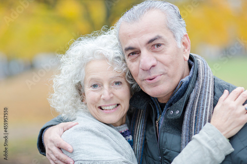 Portrait smiling, affectionate senior couple hugging in park