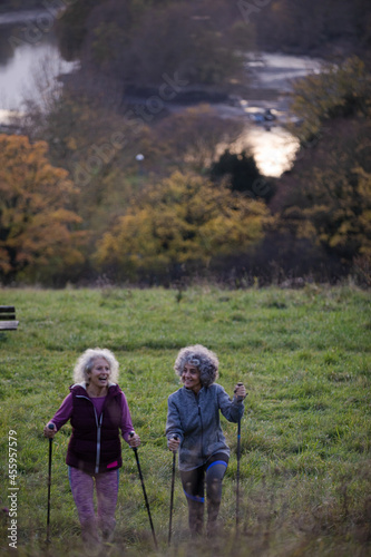Portrait smiling, happy active senior women friends with walking sticks
