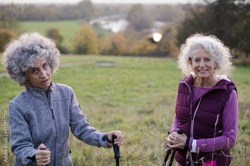 Portrait smiling, happy active senior women friends  with walking sticks
