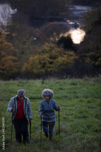 Affectionate senior couple with walking sticks