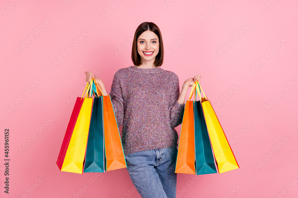 Photo of pretty customer lady hold many retail packages wear knitted pullover isolated pink color background
