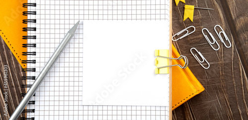 Sticker on the notebook with pencil on wooden background photo