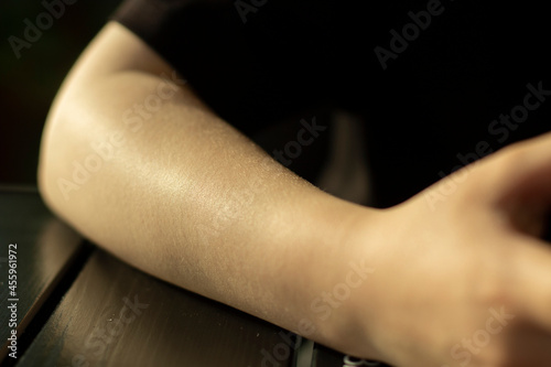 Girl's elbow. A hand without clothes. From shoulder to brush.