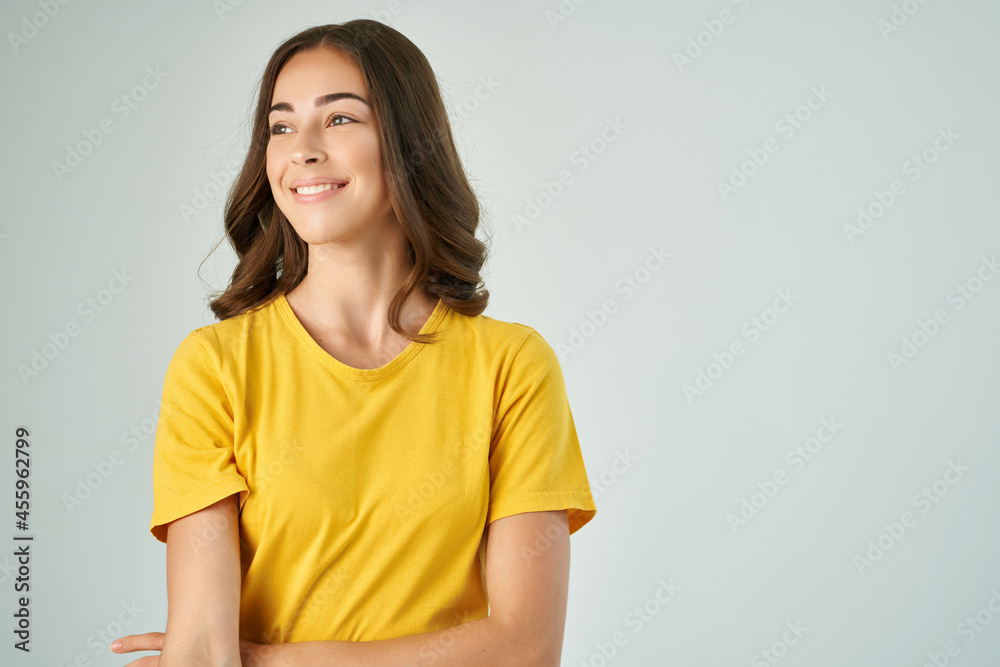 smiling woman in yellow t-shirt fashionable hairstyle posing close-up smiling woman in yellow t-shirt fashionable hairstyle posing close-up