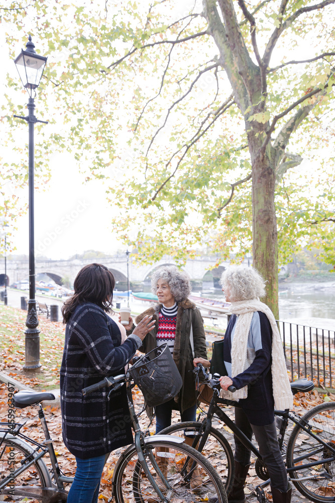 Portrait confident, smiling senior women bike riding in autumn park Portrait confident, smiling senior women bike riding in autumn park