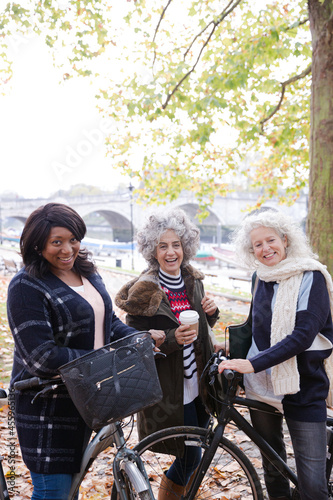 Portrait confident, smiling senior women bike riding in autumn park © KOTO