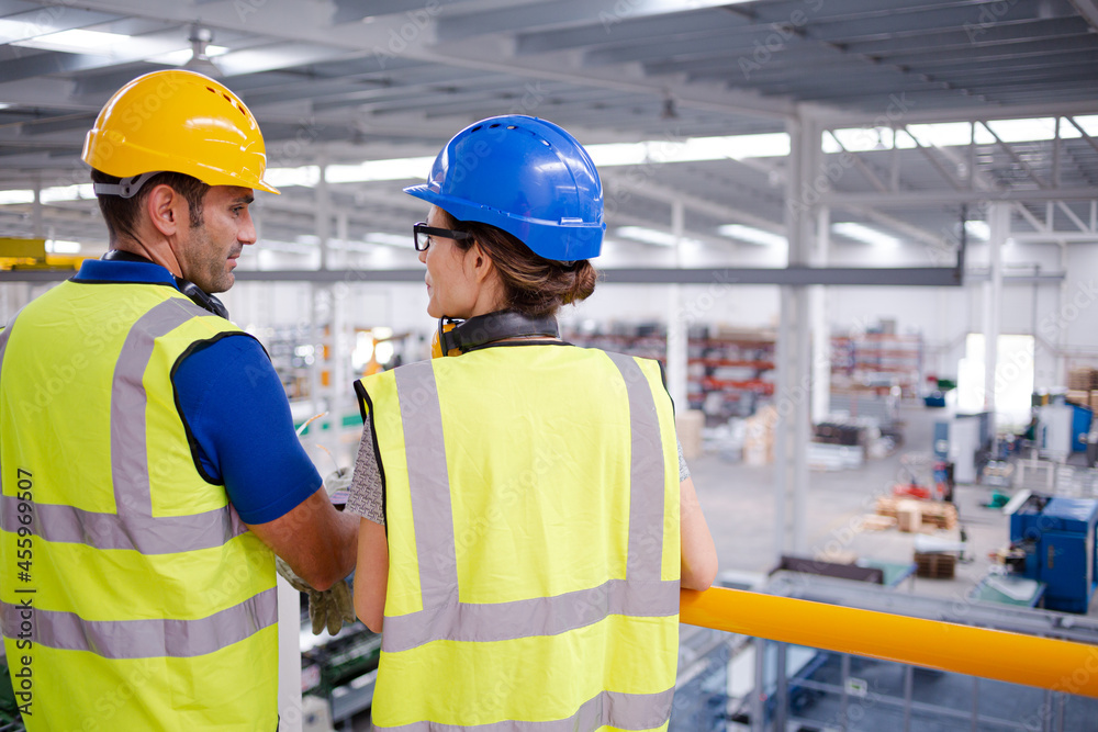 Supervisor and worker talking in steel factory Supervisor and worker talking in steel factory