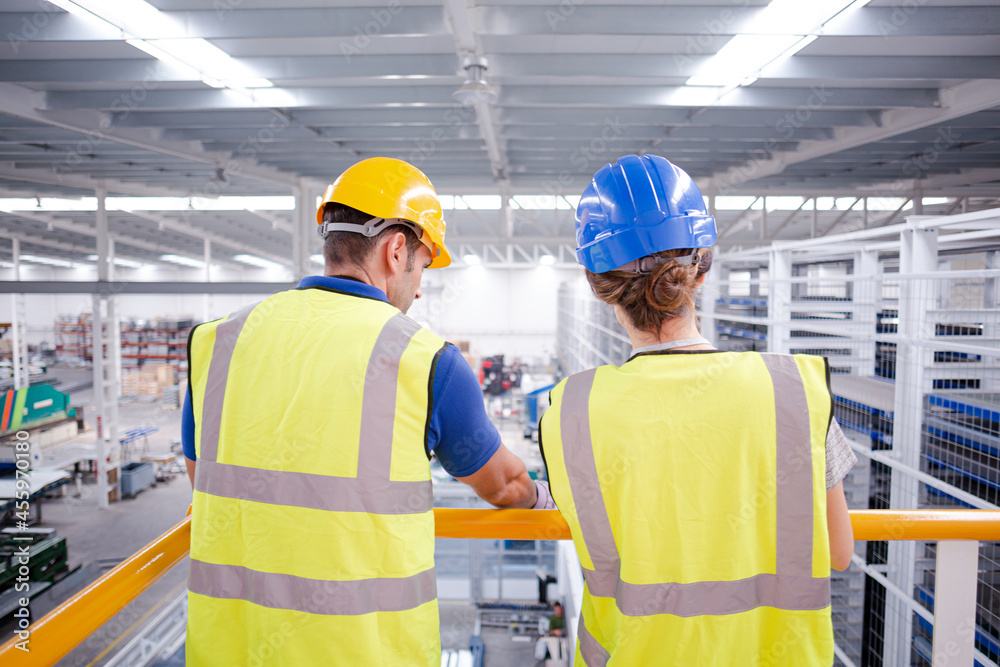 Supervisor and worker talking in steel factory Supervisor and worker talking in steel factory