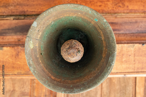 Old bell corroded by rust with the predominant brown color 