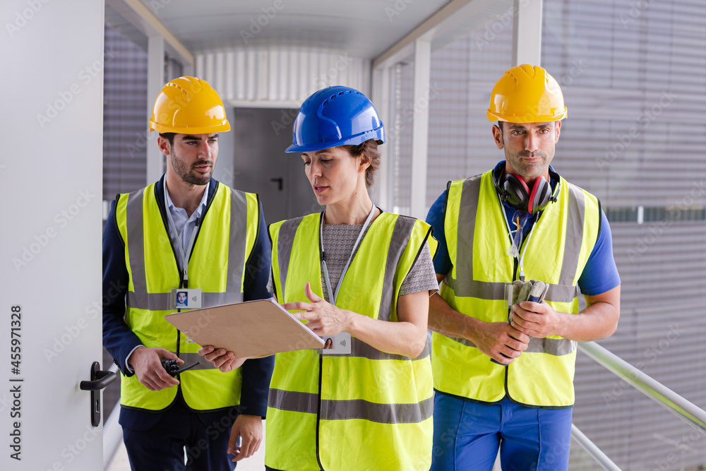 Supervisors and worker with clipboard in factory Supervisors and worker with clipboard in factory