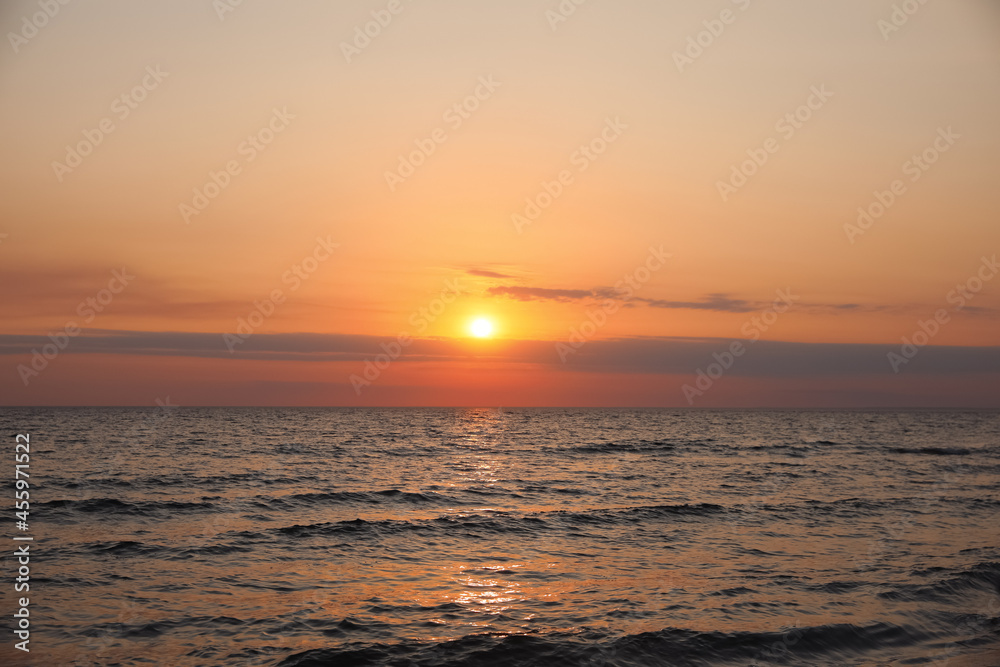 Beautiful sky with sun over sea during sunset