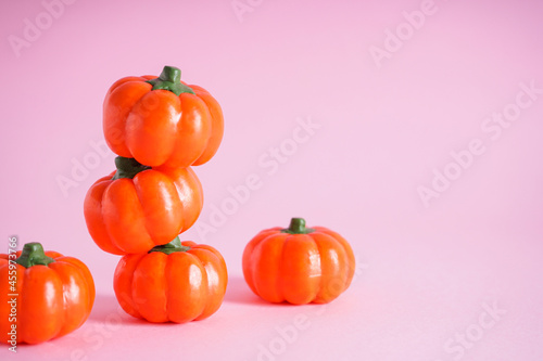 Halloween pumpkins on a pink background, space for text. Halloween concept.