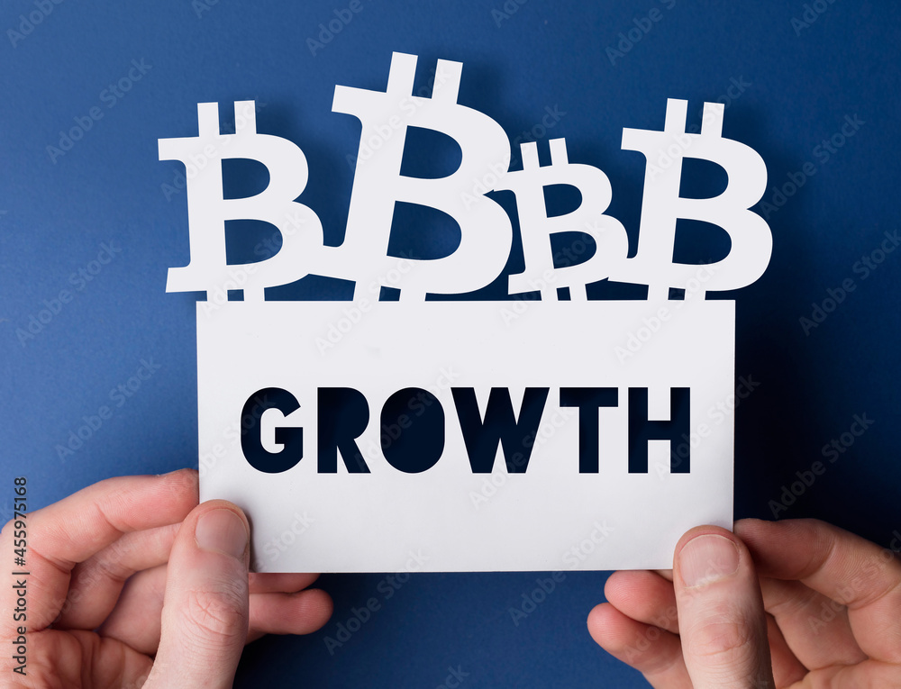 Hands holding a bitcoin cryptocurrency growth sign Hands holding a bitcoin cryptocurrency growth sign