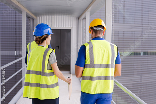 Supervisors and worker talking in factory