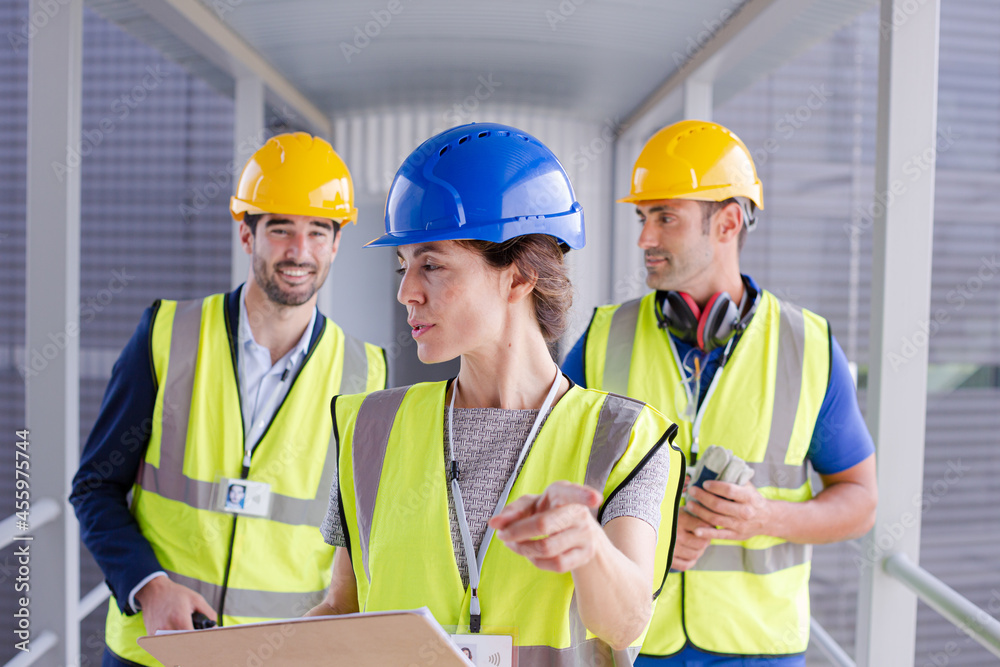 Supervisors and worker with clipboard in factory Supervisors and worker with clipboard in factory