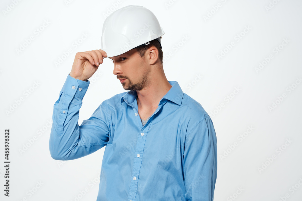 male builder with drawings in hand hand gesture light background