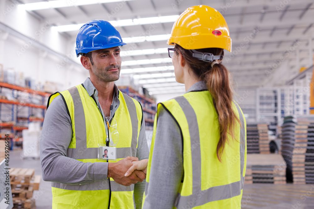 Supervisors handshaking in warehouse Supervisors handshaking in warehouse