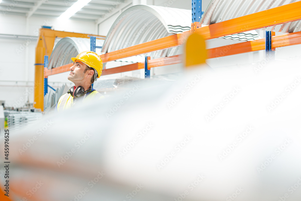 Naklejka premium Male worker looking up in factory