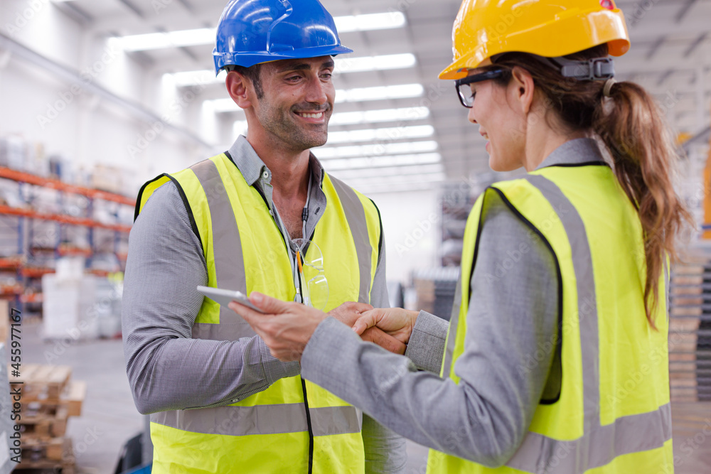 Supervisors handshaking in warehouse Supervisors handshaking in warehouse