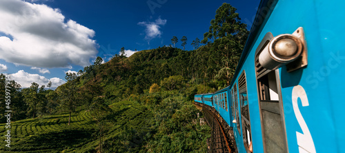 Blue train in Sri Lanka, panorama. Train from Ella in Nuwara Eliya in Sri Lanka island. Travel to Sri Lanka, the blue train travels through tea plantations. Traveling by train. Copy space photo