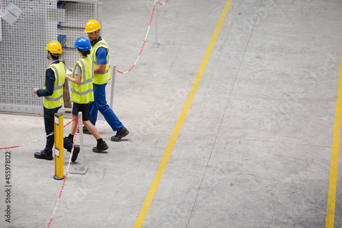 Supervisor and workers walking in factory