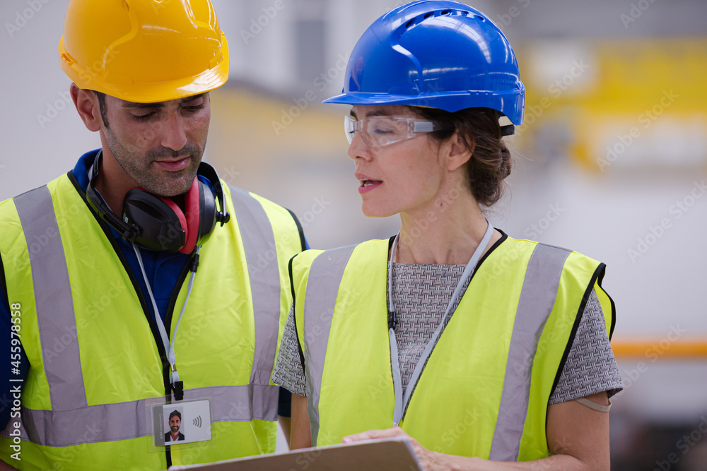 Supervisor and worker talking in factory Supervisor and worker talking in factory