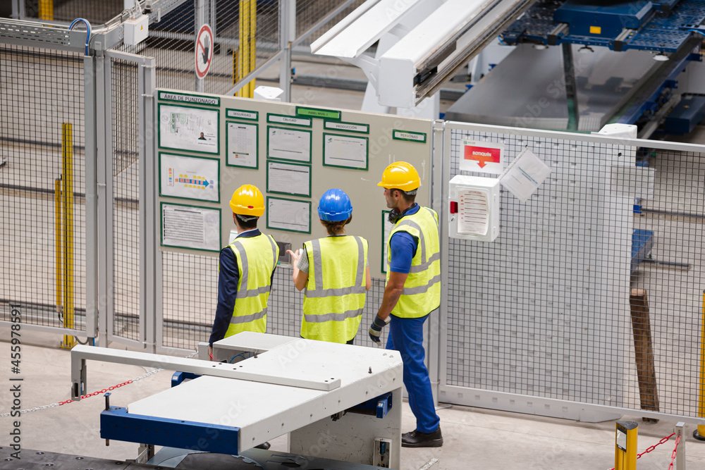 Supervisor and workers talking in factory Supervisor and workers talking in factory