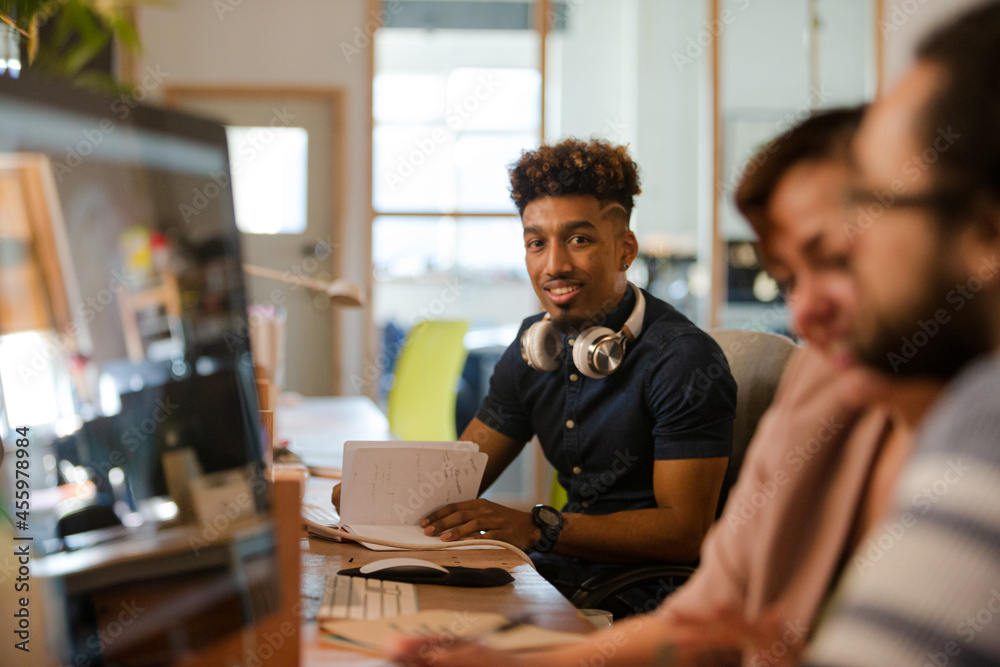 Smiling young man working at desk Smiling young man working at desk