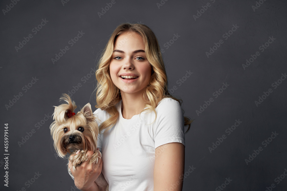 blonde with a small dog makeup posing dark background blonde with a small dog makeup posing dark background