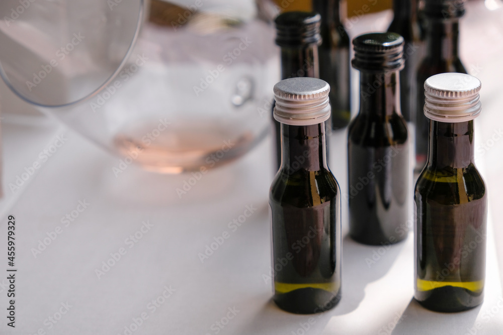Black, white corks on wine samples. A blurred image of a glass of wine. Copy space. Black, white corks on wine samples. A blurred image of a glass of wine. Copy space.