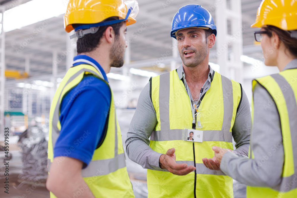 Supervisor and workers talking in steel factory Supervisor and workers talking in steel factory