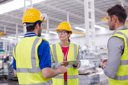 Supervisor and workers talking in steel factory