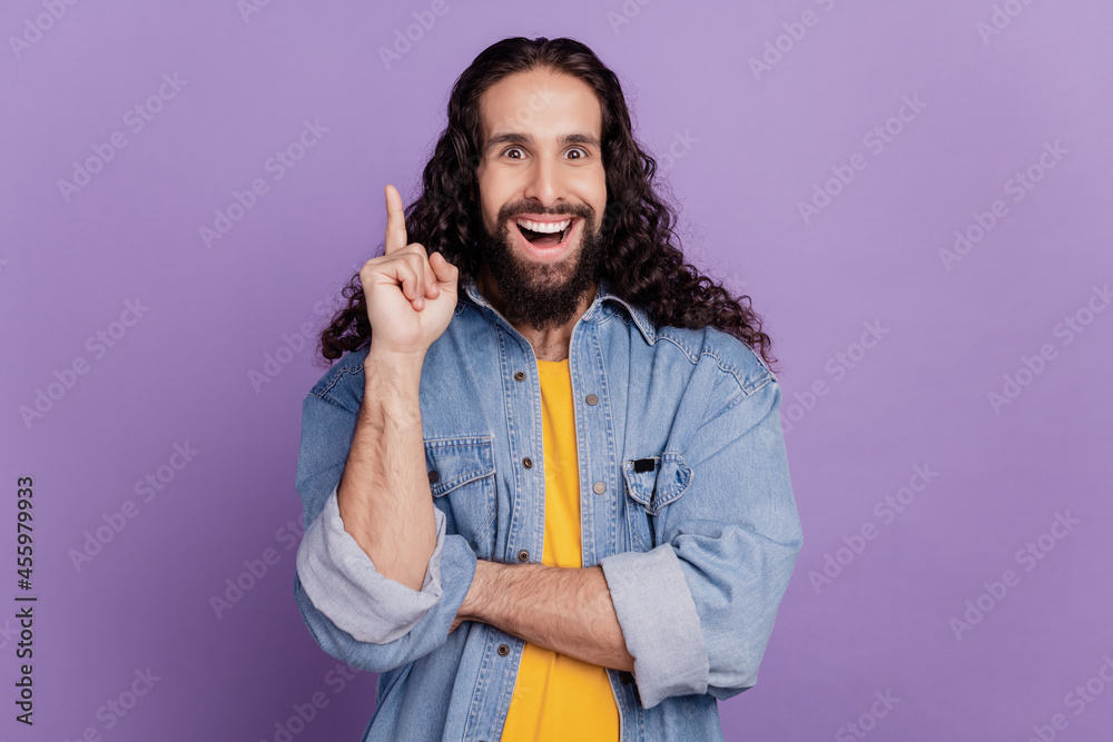 Portrait of positive genius bearded man raise finger have creative idea on purple wall