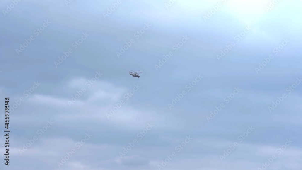 The helicopter flies across the sky The helicopter flies across the sky