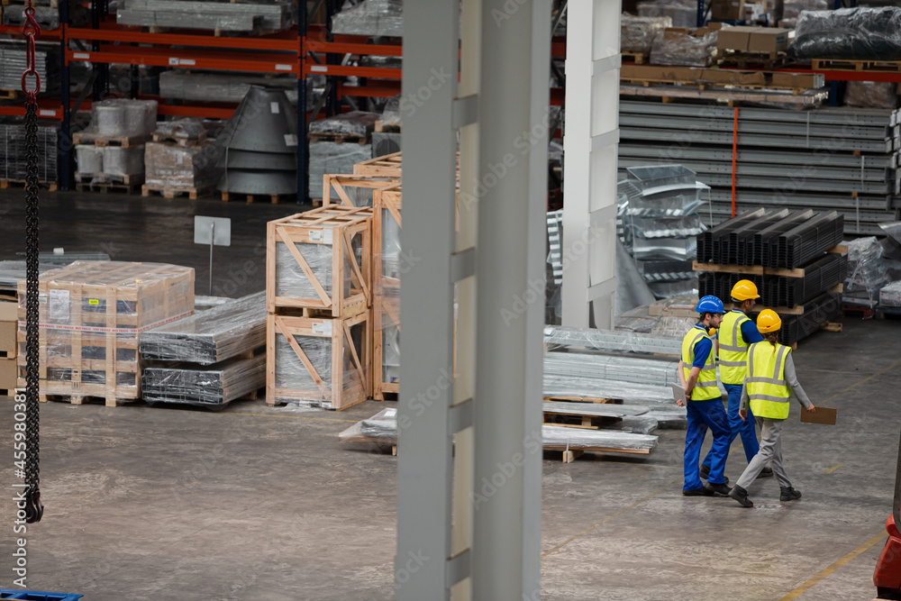 Workers and supervisor walking in factory Workers and supervisor walking in factory