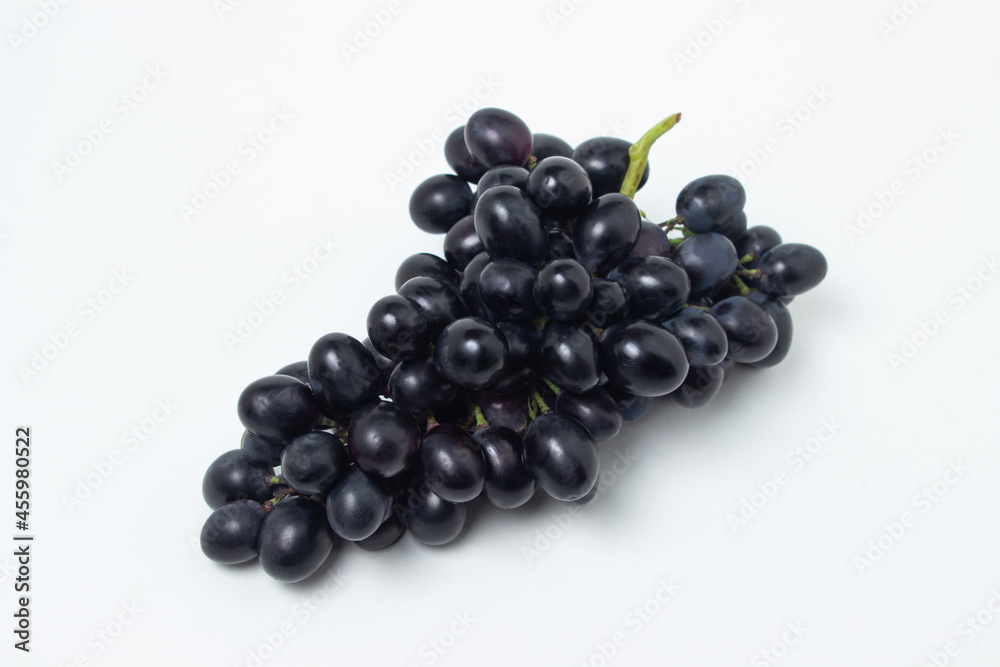 Black grapes on a white background. Fresh juicy grapes