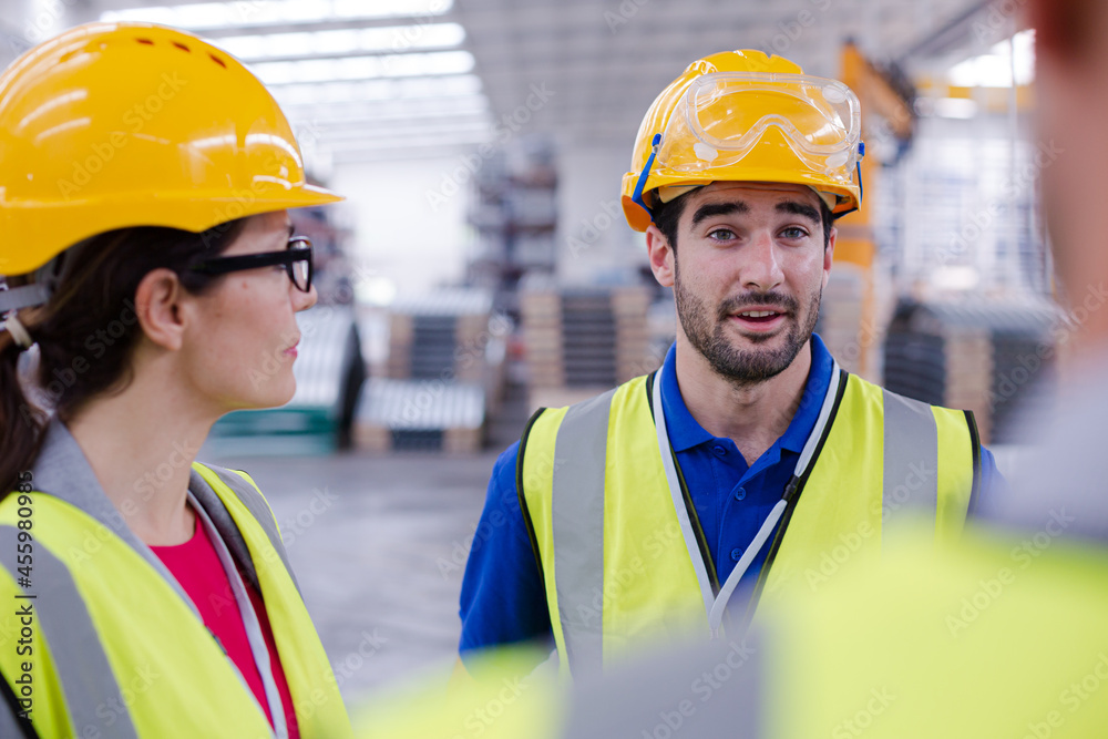 Workers talking in steel factory
