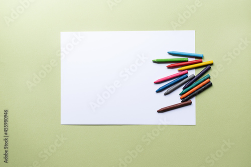 colorful crayons and blank paper