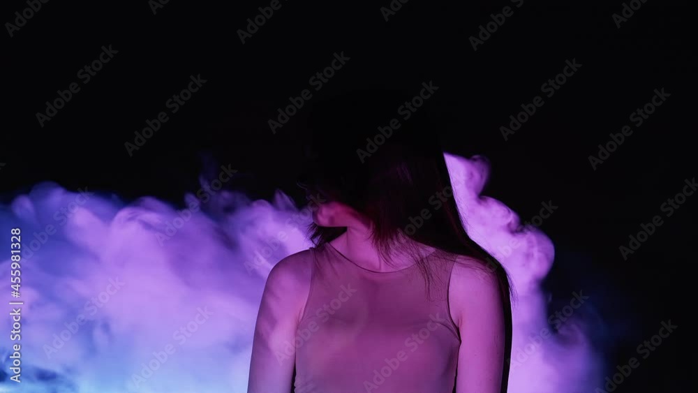 Female mystery. Introvert personality. Single lifestyle. Mystical smiling woman in purple fantasy mist cloud flow motion double exposure projection dark free space.