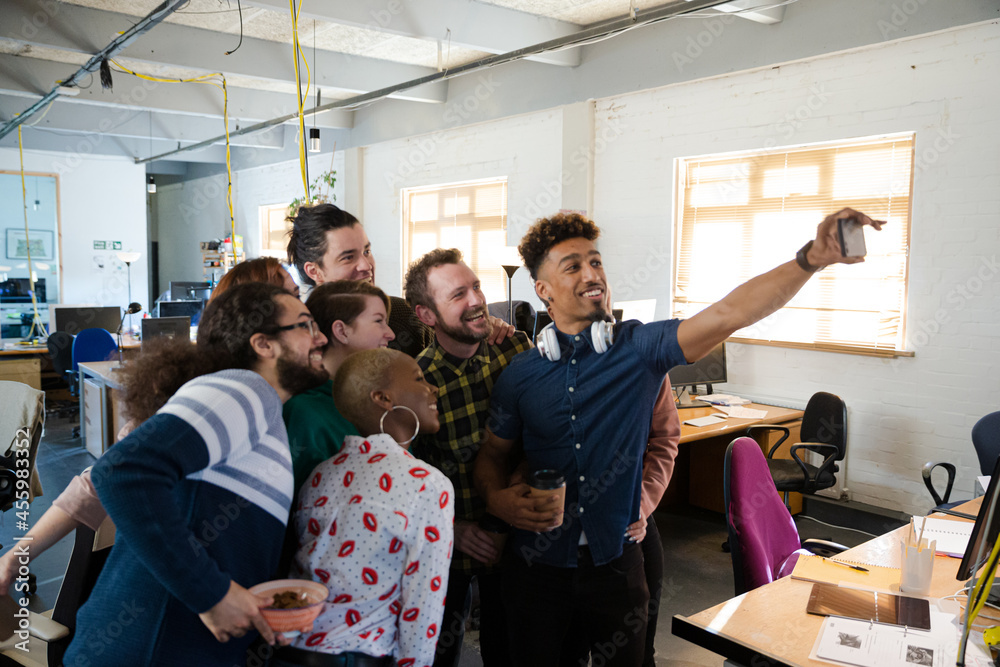 Team taking group selfie in office Team taking group selfie in office