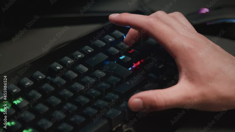 Pressing buttons on a backlit keyboard close-up Pressing buttons on a backlit keyboard close-up