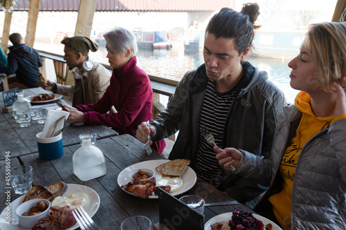 Couple sharing breakfast at restaurant outdoor patio