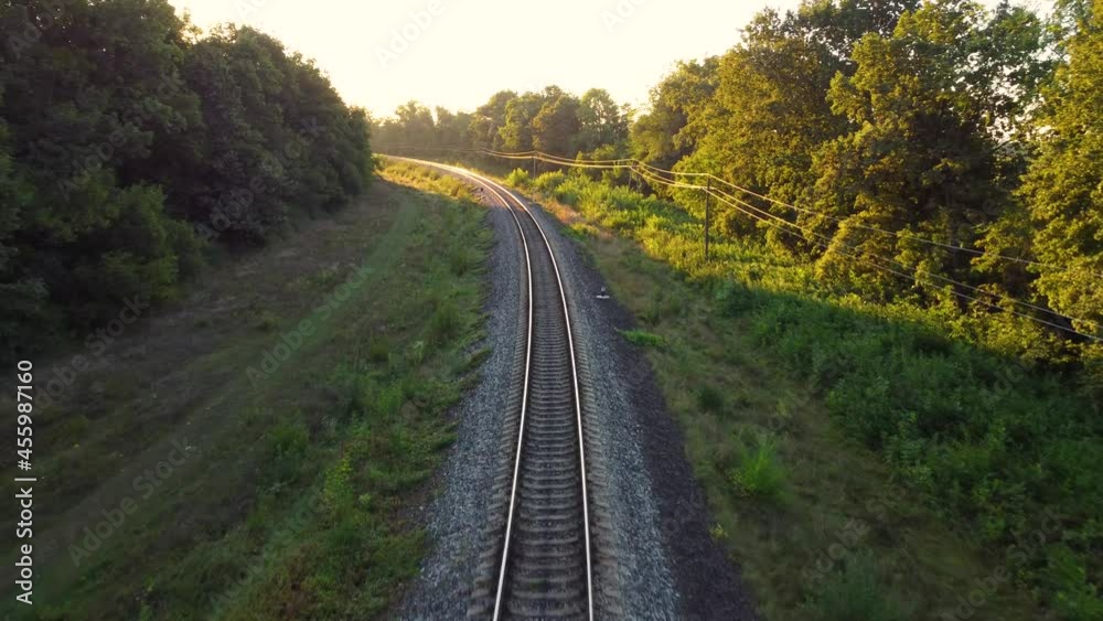 Railway traffic from the shade of trees to the morning sunlight Railway traffic from the shade of trees to the morning sunlight