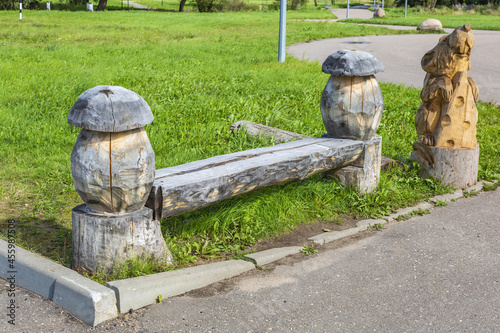 A recreation bench made of wood in a city park in summer sunny day