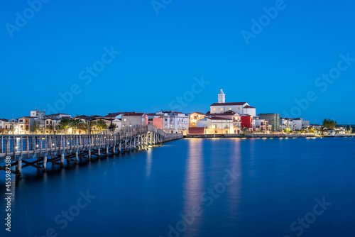 Lesina, Foggia district, Puglia, Italy, Europe, the walkway leading to the island of San Clemente, in the background the village photo