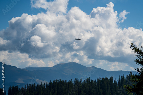 a piper in the air over the cloudy alps in austria