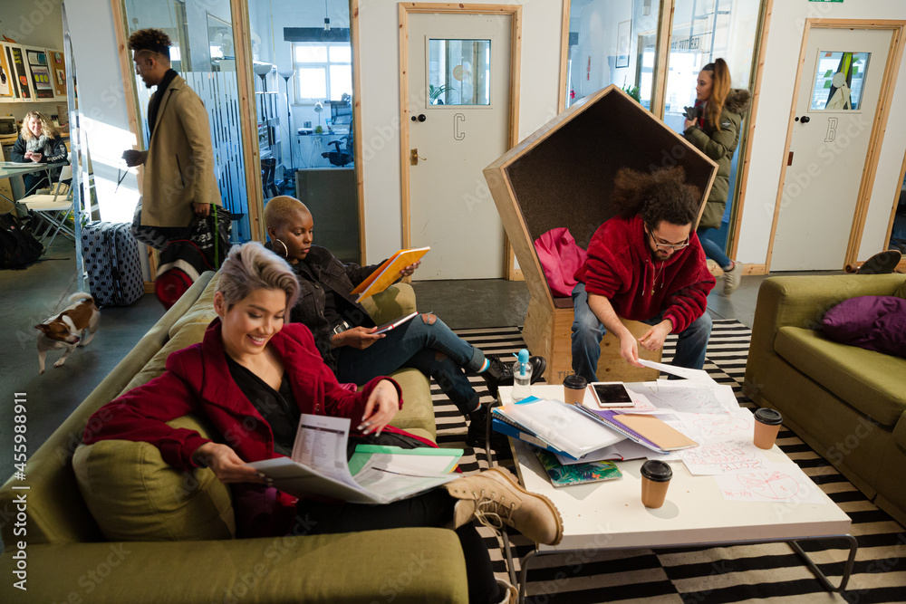 Fototapeta premium Man and woman reviewing paperwork in cosy office