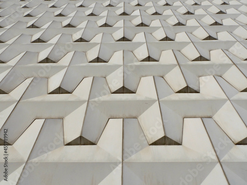 Geometric texture of the gray facade of a building in the city