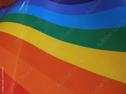 Electromagnetic spectrum on a wave-shaped plastic surface. Similar to Flag of Pride and Flag of Peace